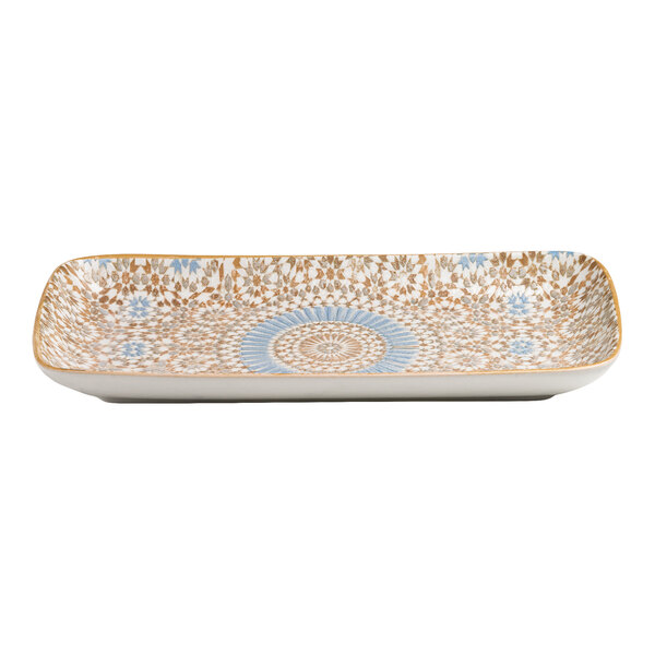 A rectangular porcelain platter with a blue and orange radial geometric design.