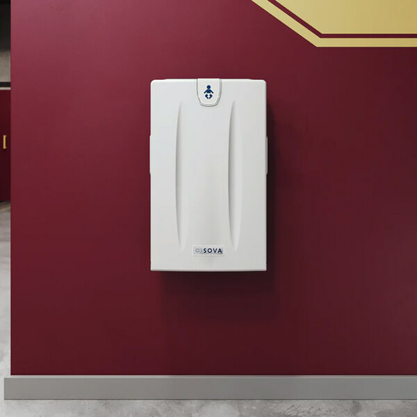 A light gray surface-mount vertical baby changing station attached to a maroon wall.