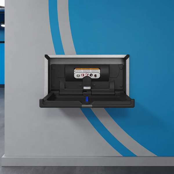 A black recessed horizontal baby changing station with a stainless steel frame mounted on a wall.
