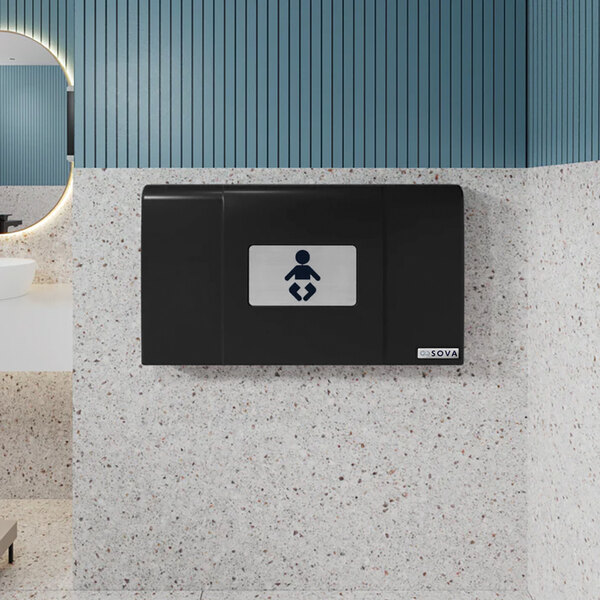 A black wall-mounted horizontal baby changing station with a symbol indicating its purpose.