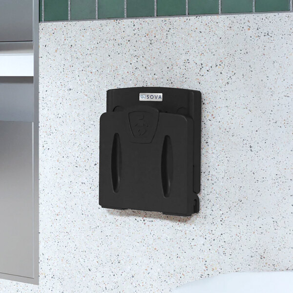 A black wall-mounted toddler safety seat.