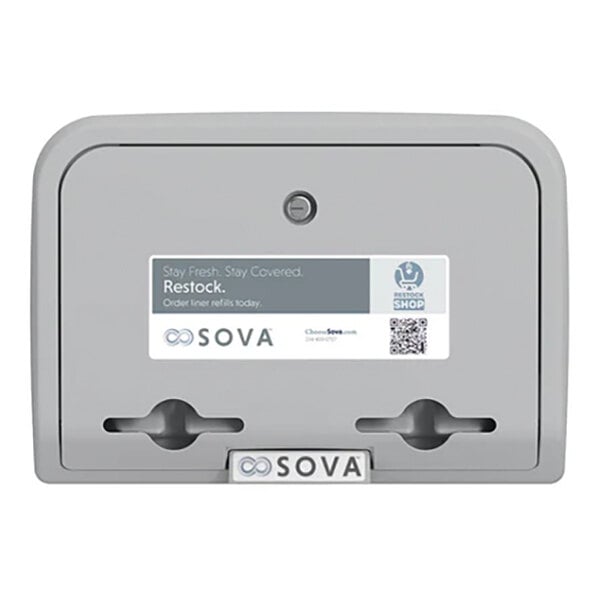 A gray wall-mounted baby changing station with a dual liner dispenser.