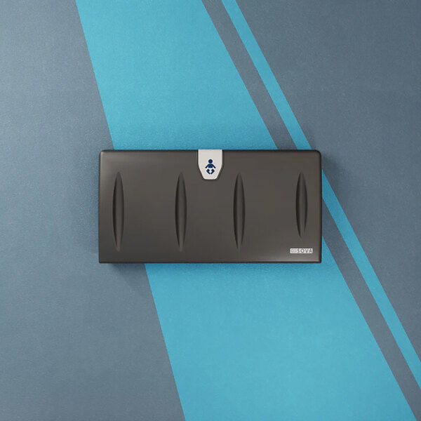 A black surface-mount horizontal baby changing station with a sleek design and a small label on the front.