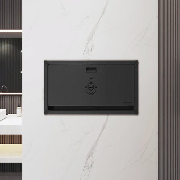 A black stainless steel surface-mount horizontal baby changing station installed on a wall.