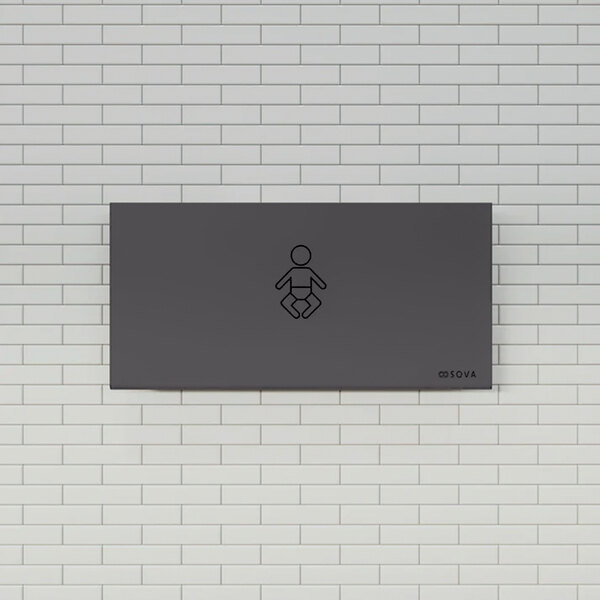 A black stainless steel horizontal baby changing station mounted on a tiled wall.