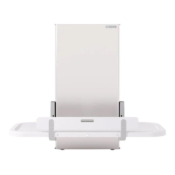 A height-adjustable wall-mounted changing station with a fold-down table and safety rails.