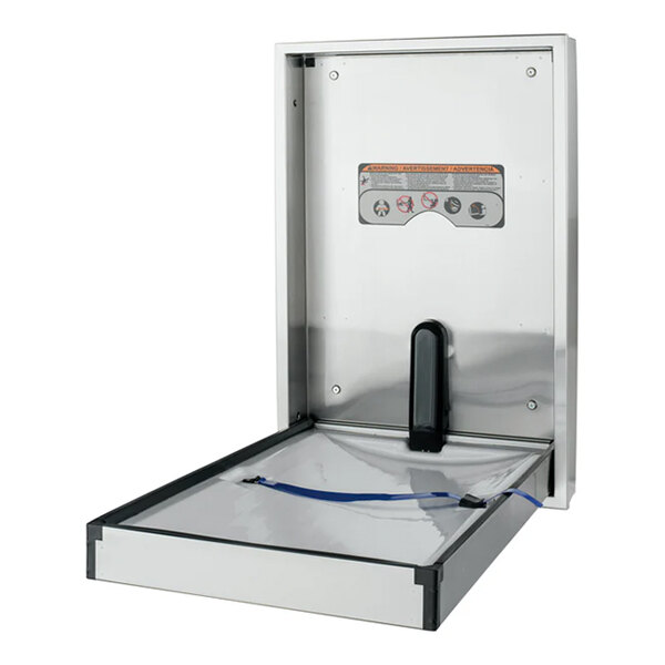 A stainless steel recessed vertical baby changing station with a safety strap and instructions on the back panel.