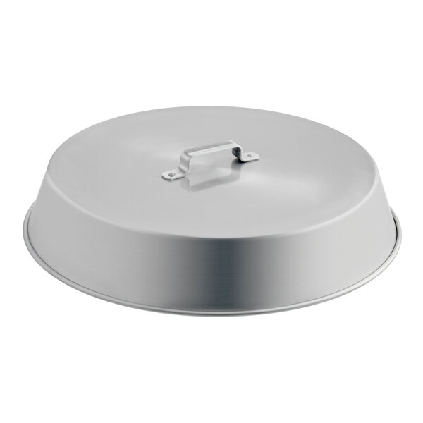 A round, metallic lid with a flat handle on top, likely made of aluminum.