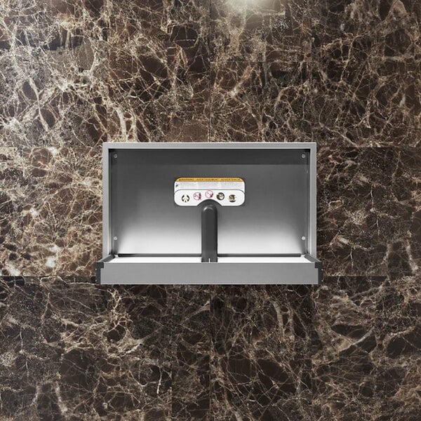 A stainless steel surface-mount horizontal baby changing station installed on a marble-patterned wall.