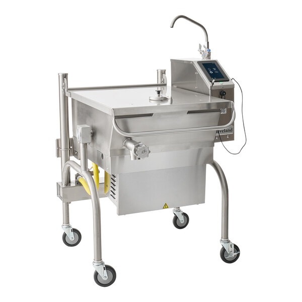 A large stainless steel commercial kitchen appliance with a tilting pan, control panel, faucet, and four caster wheels.