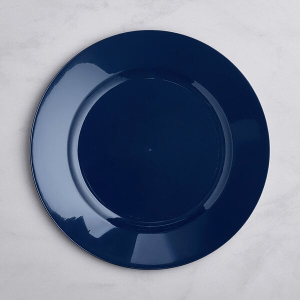 A round, glossy navy blue plate is shown on a light-colored surface.