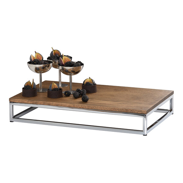 A rectangular flat tray made of chocolate brown oak wood with a metal frame base.