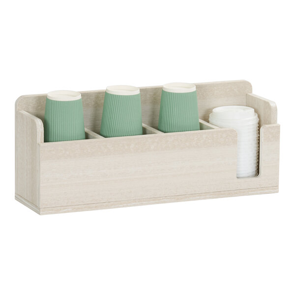 A four-compartment light wood cup and lid organizer holding green and white cups.