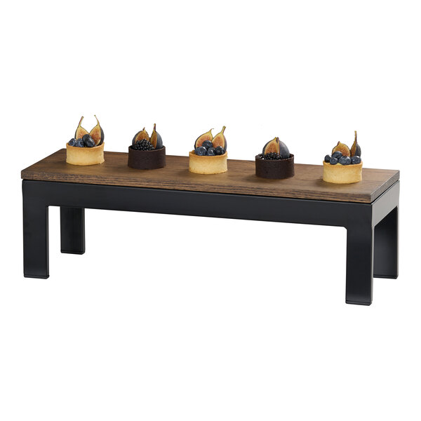 A rectangular chocolate brown oak wood tray with a flat surface and black legs, used for displaying food items.