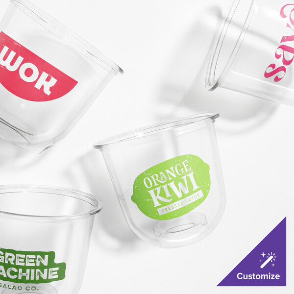 A set of clear, customizable 12 oz. plant-based PLA plastic cold cups with rounded bottoms and colorful printed labels.