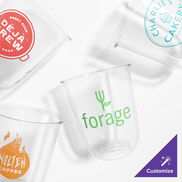 A set of clear, customizable plant-based plastic cold cups with various printed logos.