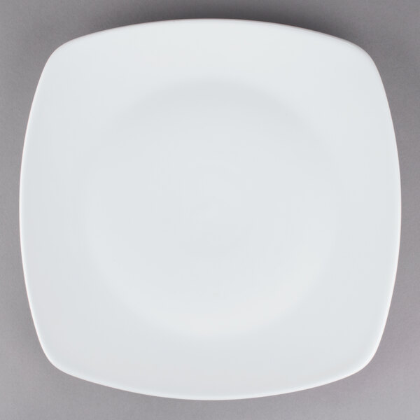 A Tuxton white square china plate with a white rim.