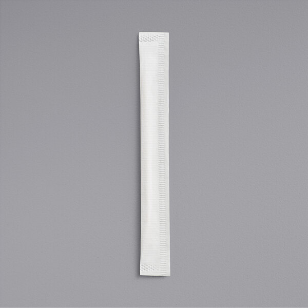 A single white paper-wrapped item, likely a toothpick, is placed vertically on a plain gray background.