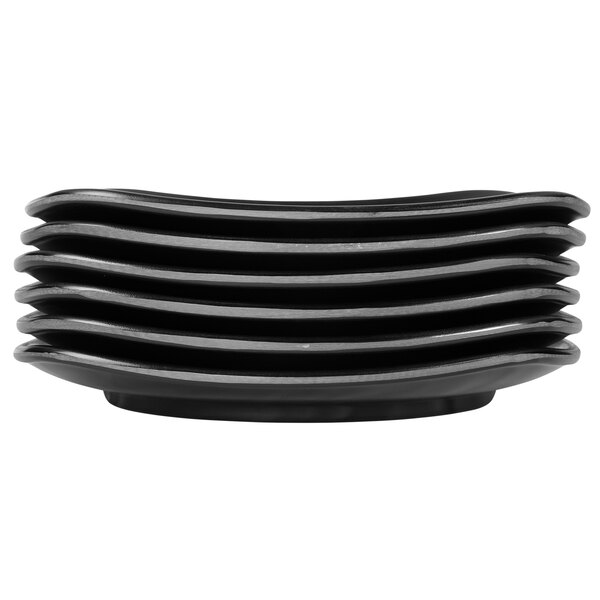 A stack of black Elite Global Solutions Ore square melamine plates.