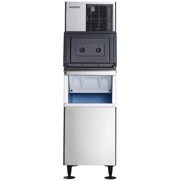 A commercial stainless steel modular crescent ice machine with an attached ice storage bin.