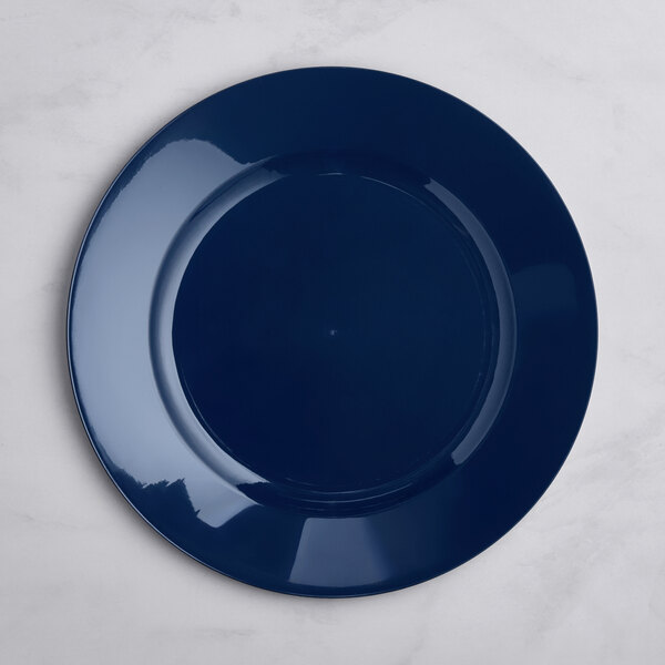 A round, glossy navy blue plate is shown on a light-colored surface.