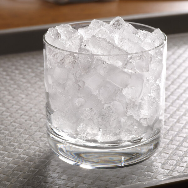 A glass filled with small, clear cubelet ice pieces.