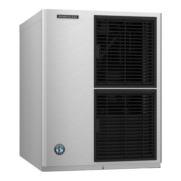 A stainless steel modular crescent ice machine with black ventilation grilles on the front.