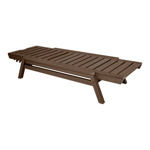 A brown adjustable and stackable poly-lumber chaise lounge with a slatted design.