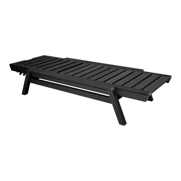 A black adjustable and stackable poly-lumber chaise lounge with a slatted design.