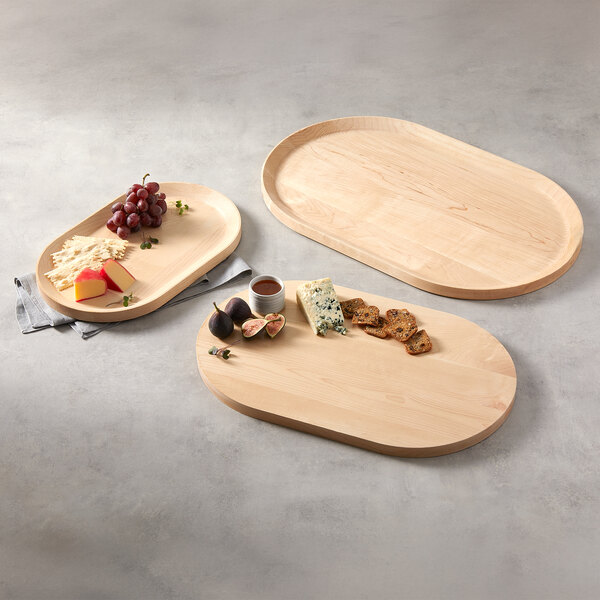 An oval maple wood serving board measuring 18 1/8 inches by 11 3/8 inches by 3/4 inch.