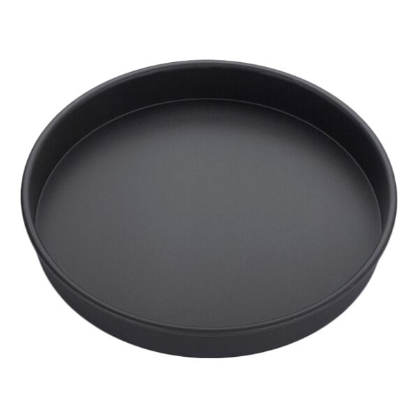 A round, black, straight-sided aluminum pizza pan.