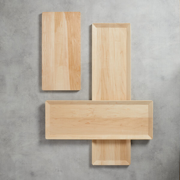 A rectangular maple wood serving board with a smooth, light finish.