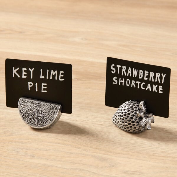 A whimsical polyresin citrus slice card holder designed to display cards or labels.