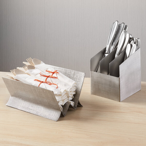 A stainless steel three-section flatware holder with an etched design, used for organizing utensils.