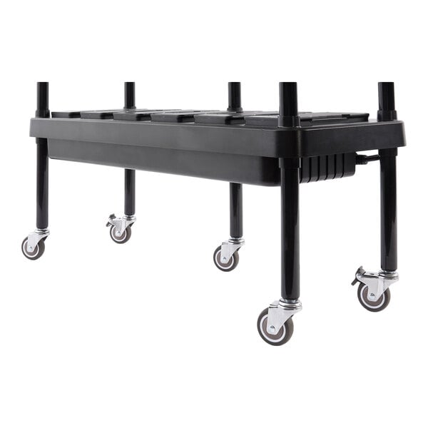 A set of four caster wheels attached to the legs of a black buffet tray cart.