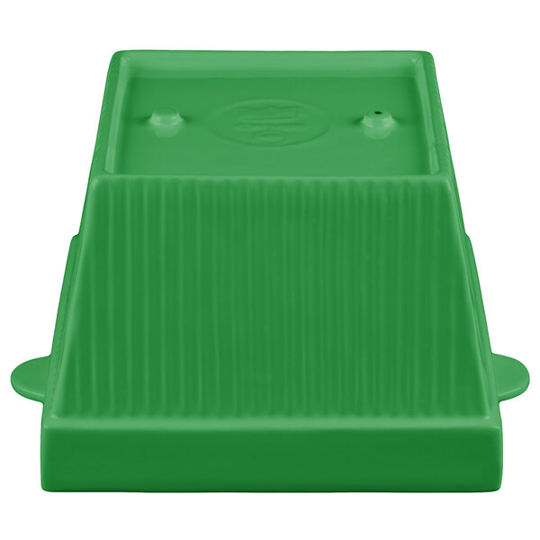 A green cast aluminum square bowl with two legs.