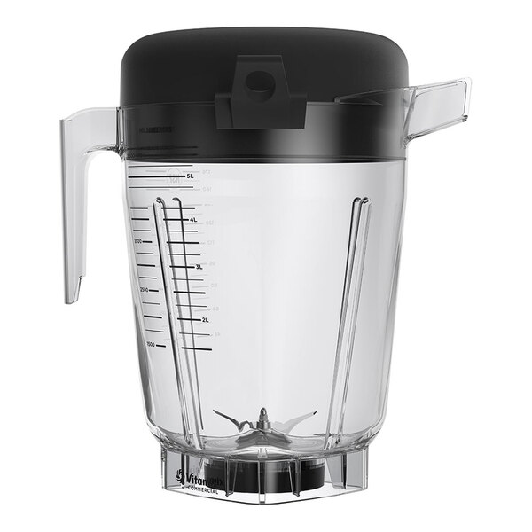 A large clear blender container with measurement markings, a handle, a spout, a black lid, and metal blades at the bottom.