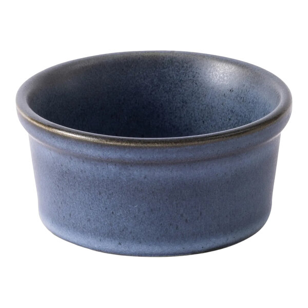 A round, matte blue porcelain ramekin with a 4 oz. capacity.