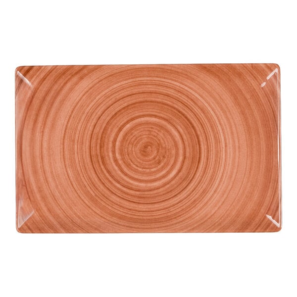 A rectangular orange melamine tray with a circular pattern design.
