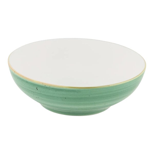 A round porcelain bowl with a white interior and mint green exterior.