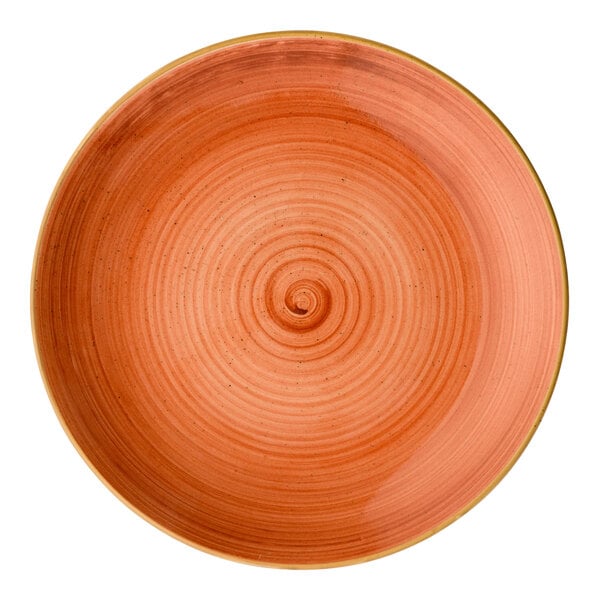 A round orange porcelain coupe plate with a concentric circle design.