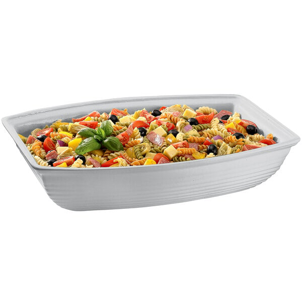 A Tablecraft natural cast aluminum oblong salad bowl filled with pasta salad on a white background.