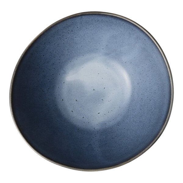A round, matte blue porcelain bowl with a subtle gradient design.