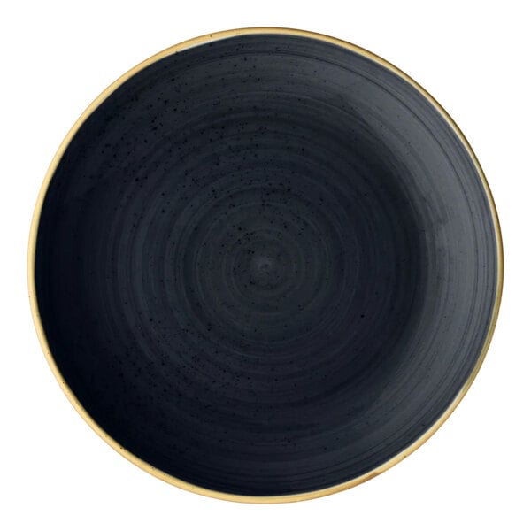 A round slate gray porcelain coupe plate with a subtle textured pattern and a thin gold rim.