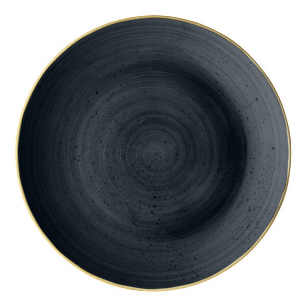 A round slate gray porcelain coupe plate with a subtle textured pattern and a thin gold rim.