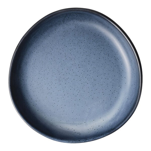 A round, matte blue porcelain plate with a slightly irregular rim.
