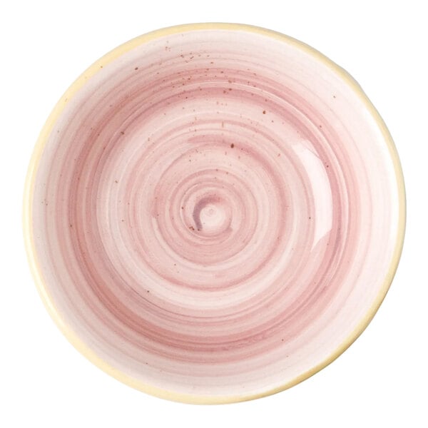 A small pink porcelain ramekin with a circular swirl pattern.