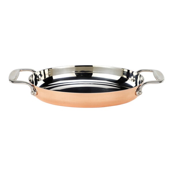 A stainless steel and copper oval roasting pan with handles.