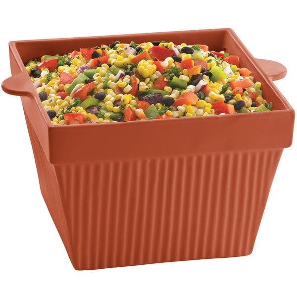 A Tablecraft copper cast aluminum square bowl filled with mixed vegetables and corn.