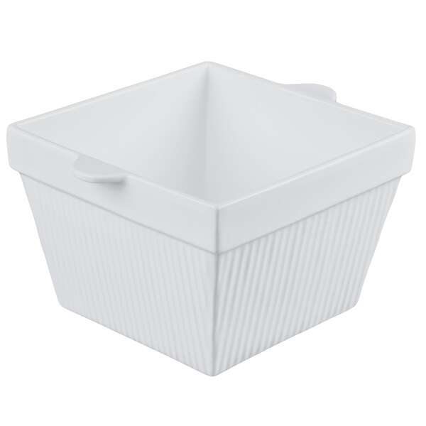 A gray square cast aluminum bowl with a handle.